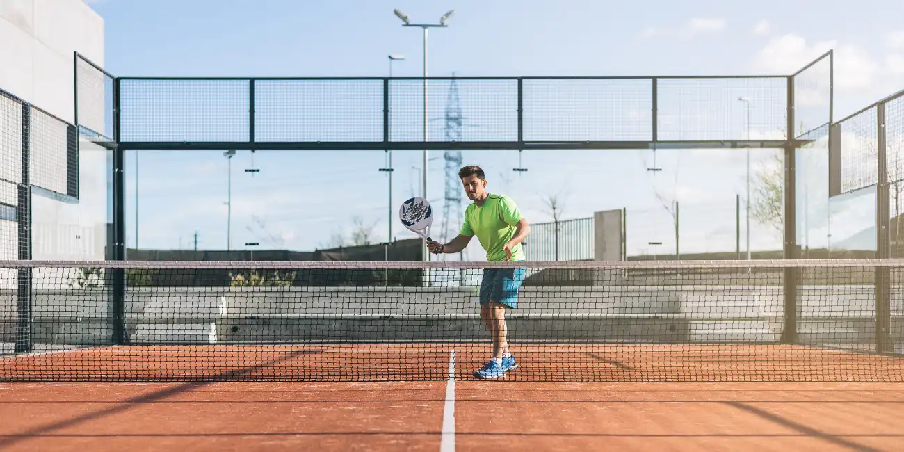 Padel coaching session on an outdoor court in Spain — padel lessons Spain group training sunny weather